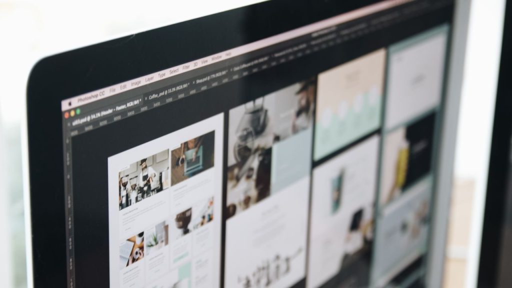 A modern computer screen displaying web design work, showcasing creative visuals in a workspace.
